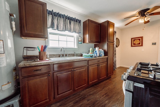 5514 Pardee St, Houston, TX 77026 - kitchen with a sink, a ceiling fan, refrigerator, gas range oven, and dark wood-style floors