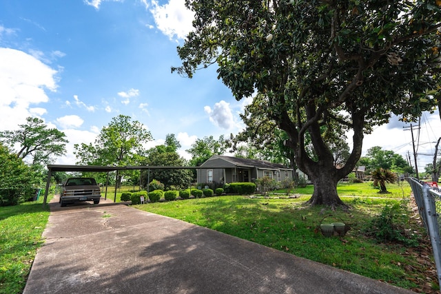 5514 Pardee St, Houston, TX 77026 - ranch-style home featuring a carport, fence, a front yard, and concrete driveway