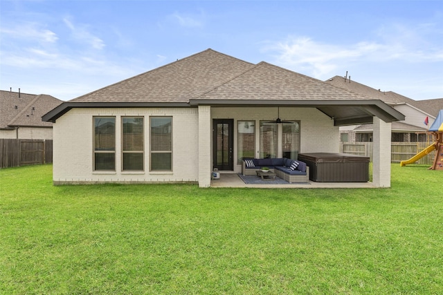 back of house with a patio area, a hot tub, a fenced backyard, a playground, and a shingled roof