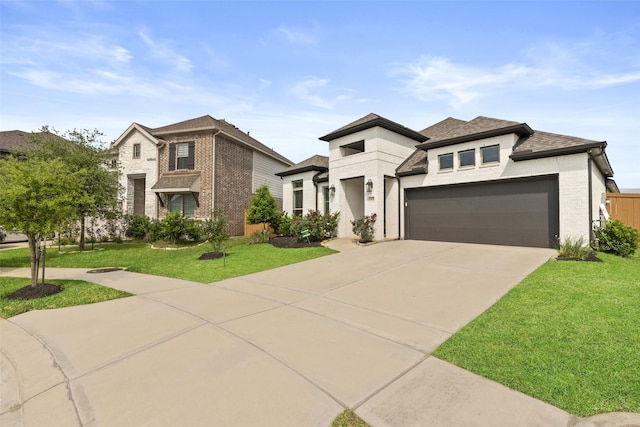 prairie-style home featuring a garage, a front yard, roof with shingles, brick siding, and concrete driveway