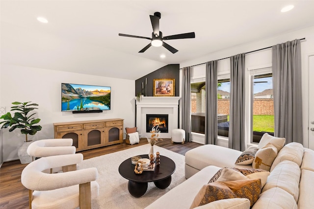 living room with dark wood-style flooring, a glass covered fireplace, ceiling fan, recessed lighting, and vaulted ceiling