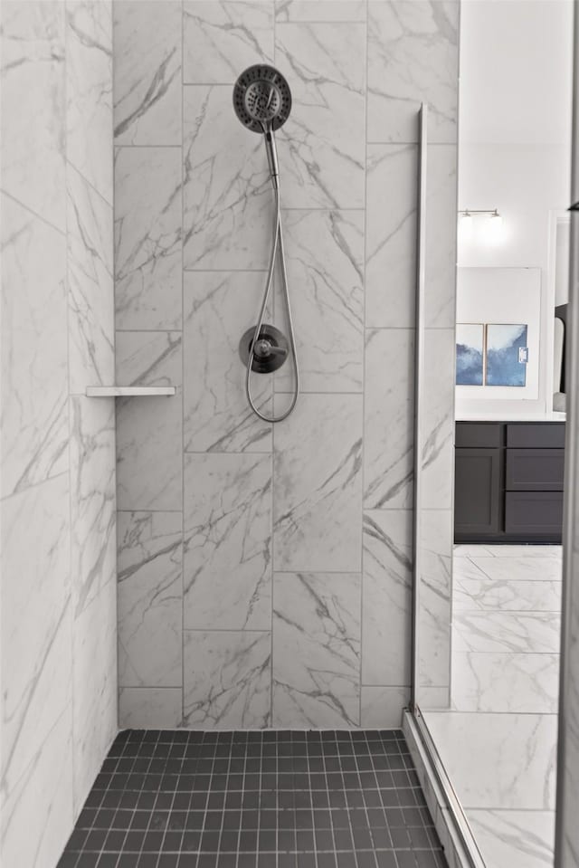 full bath with vanity and a tile shower