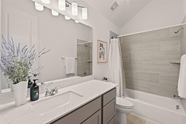 bathroom featuring vanity, toilet, shower / bath combination with curtain, vaulted ceiling, and visible vents