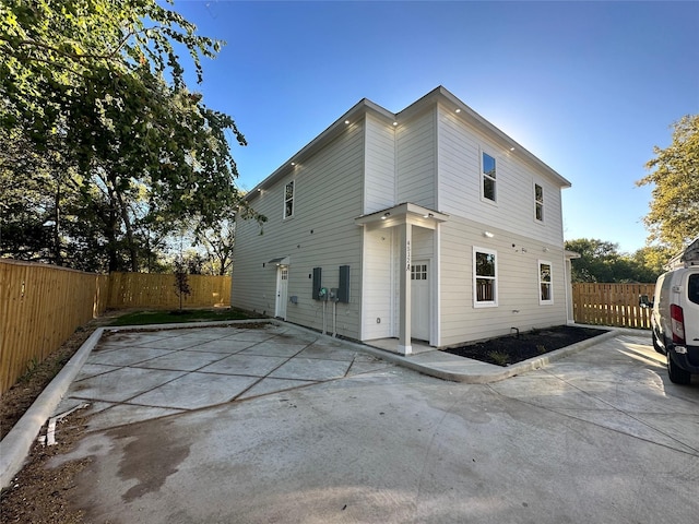 back of house featuring a fenced backyard and a patio area