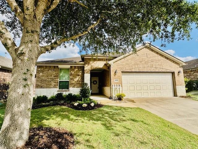 single story home featuring concrete driveway, brick siding, a garage, and a front lawn
