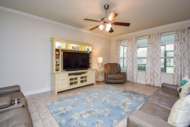 living room featuring a ceiling fan, light tile patterned floors, baseboards, ornamental molding, and a healthy amount of sunlight
