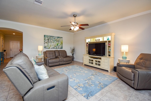 living room featuring arched walkways, ceiling fan, crown molding, and visible vents