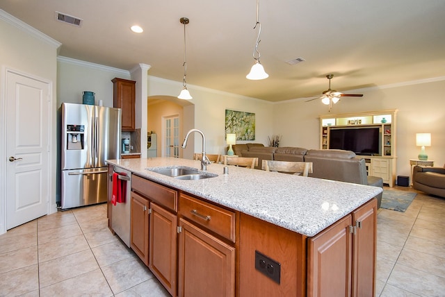kitchen with a sink, crown molding, stainless steel appliances, and visible vents