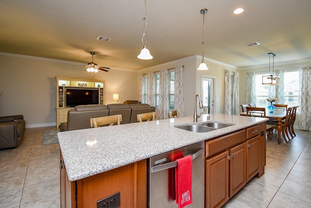 kitchen with a kitchen island with sink, light tile patterned floors, stainless steel dishwasher, and a sink