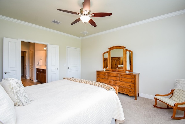 bedroom featuring ensuite bathroom, visible vents, crown molding, a ceiling fan, and baseboards