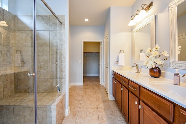 full bath with a sink, tile patterned flooring, and a shower stall
