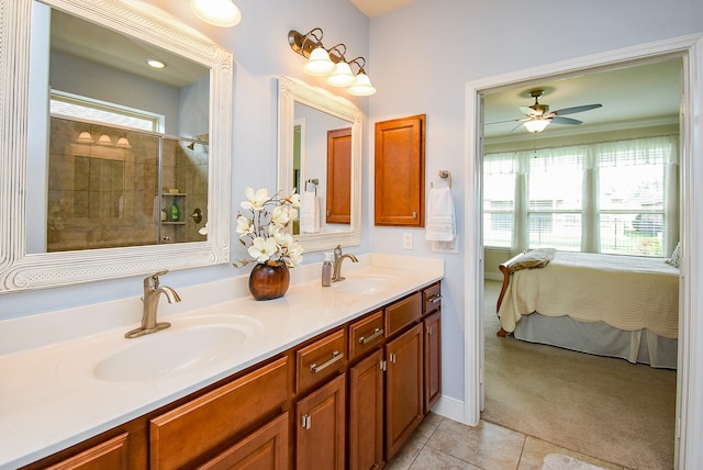 ensuite bathroom featuring ensuite bath, tile patterned flooring, a ceiling fan, and a sink