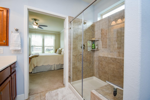 ensuite bathroom featuring a shower stall, a wealth of natural light, and ceiling fan