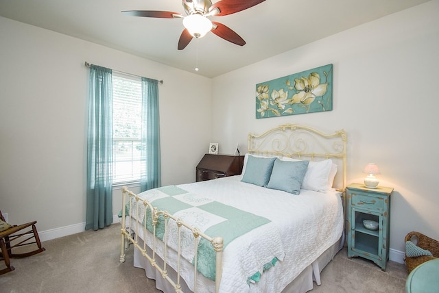 bedroom with carpet, baseboards, and a ceiling fan