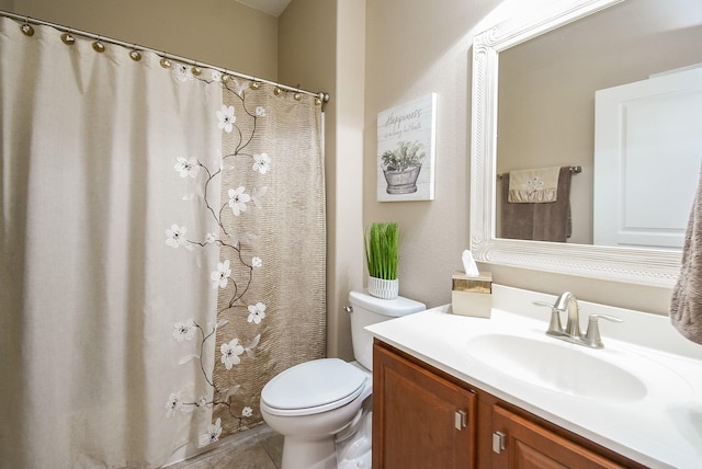 bathroom featuring toilet, tile patterned floors, and vanity