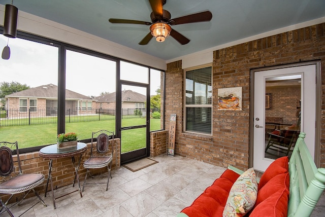 sunroom / solarium with ceiling fan and an outdoor hangout area