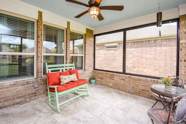 sunroom with a wealth of natural light and ceiling fan
