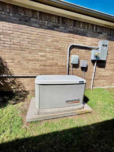 details with a power unit, brick siding, and electric meter