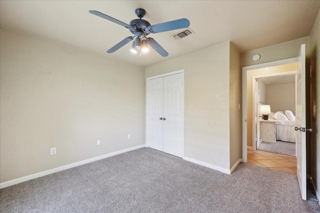 unfurnished bedroom with visible vents, a closet, baseboards, and carpet floors