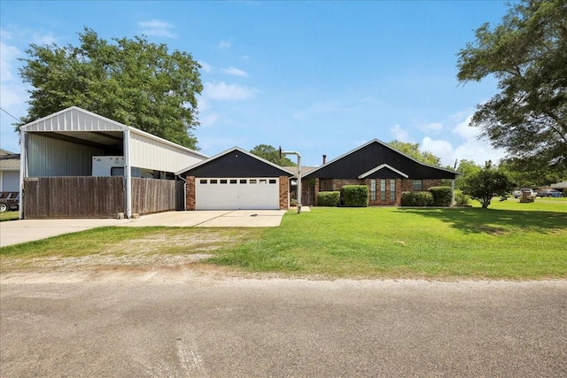 view of front of home featuring concrete driveway, a detached carport, a front yard, and fence