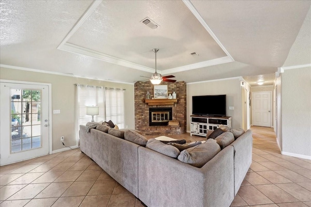 living room featuring light tile patterned flooring, a raised ceiling, and visible vents