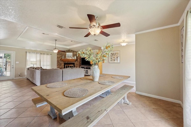 dining space featuring light tile patterned floors, ceiling fan, a raised ceiling, and baseboards