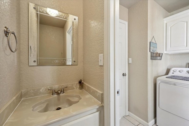 bathroom with washer / clothes dryer, tile patterned flooring, and vanity