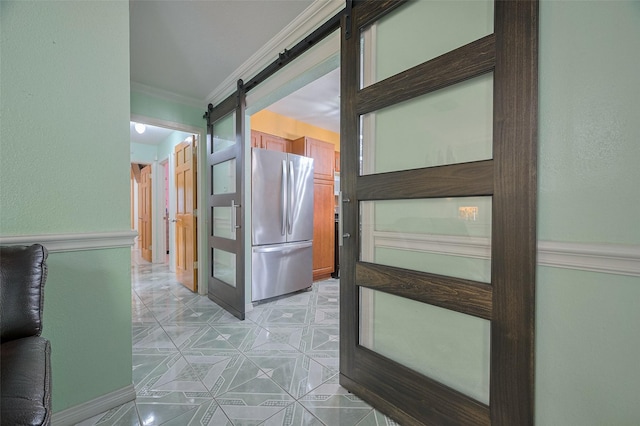 hallway featuring a barn door and ornamental molding