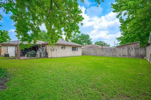 view of yard with a fenced backyard