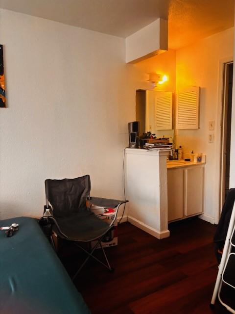 6200 W Tidwell Rd Unit 1701, Houston, TX 77092 - living area featuring dark wood finished floors and baseboards