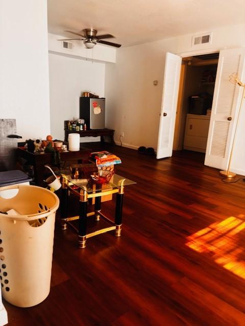 6200 W Tidwell Rd Unit 1701, Houston, TX 77092 - living area featuring wood finished floors, ceiling fan, and baseboards
