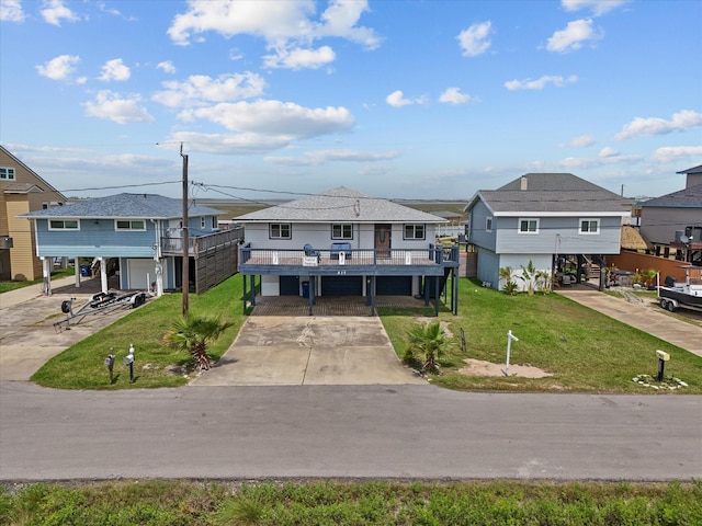 517 Swordfish Ln, Surfside Beach, TX 77541 - view of front of house with a carport, driveway, a residential view, and a front yard