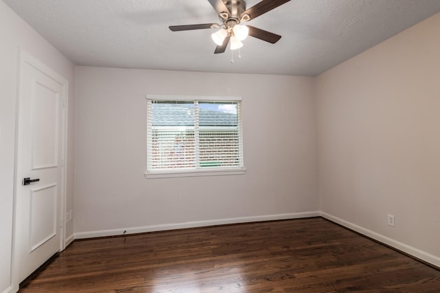 spare room with a ceiling fan, wood finished floors, and baseboards
