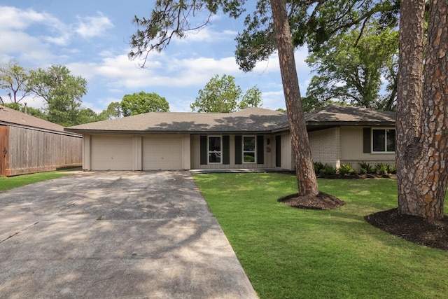 ranch-style home featuring driveway, fence, a front lawn, and an attached garage