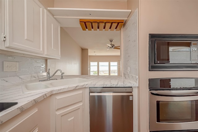 10 Mariner Village Dr, Pasadena, TX 77586 - kitchen featuring backsplash, dishwasher, a sink, white cabinetry, and built in microwave