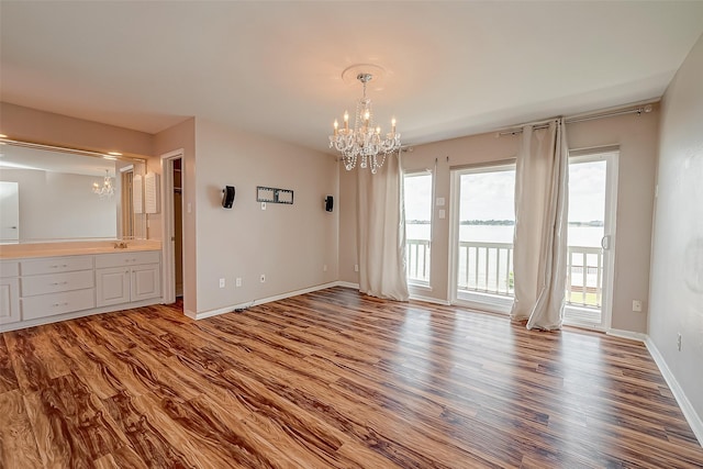 10 Mariner Village Dr, Pasadena, TX 77586 - interior space featuring an inviting chandelier, a sink, wood finished floors, and baseboards