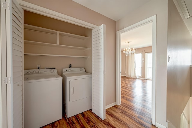 10 Mariner Village Dr, Pasadena, TX 77586 - washroom featuring wood finished floors, laundry area, washer and dryer, baseboards, and a notable chandelier