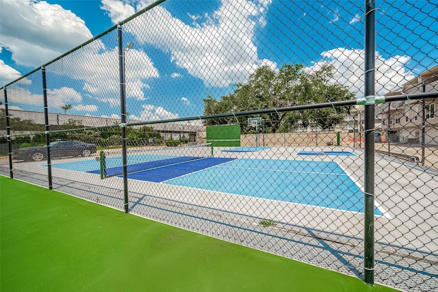 10 Mariner Village Dr, Pasadena, TX 77586 - view of swimming pool featuring a tennis court, fence, and community basketball court