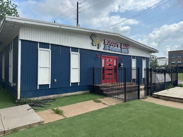 view of building exterior with fence