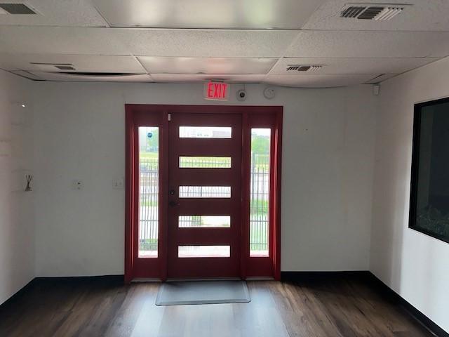 entrance foyer featuring wood finished floors, visible vents, and a paneled ceiling