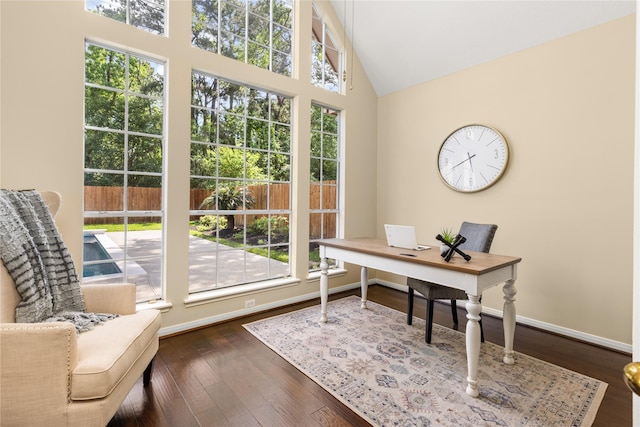 office space with baseboards, a wealth of natural light, and dark wood-style flooring