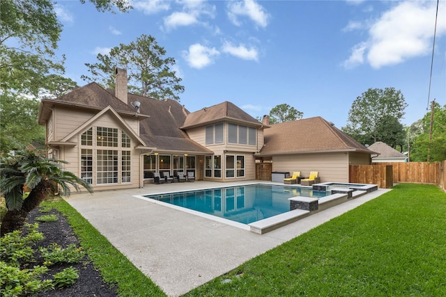 view of pool featuring a patio, a pool with connected hot tub, a fenced backyard, outdoor lounge area, and a lawn