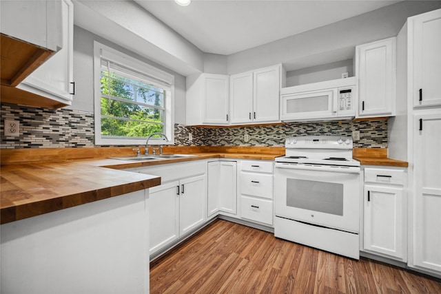kitchen featuring wooden counters, a sink, white cabinets, and white appliances