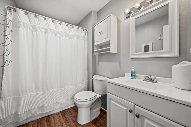 full bath featuring curtained shower, wood finished floors, toilet, and vanity