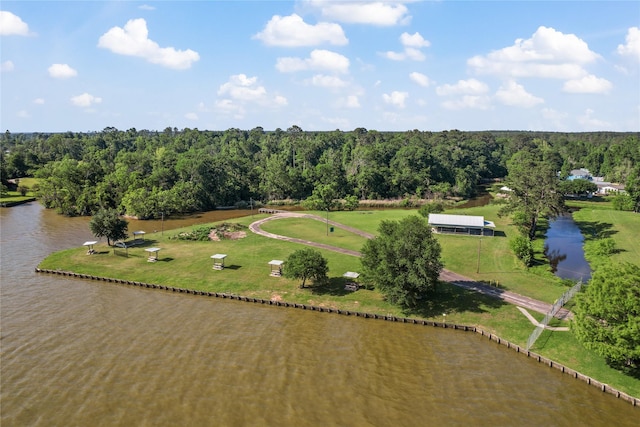 aerial view with a wooded view and a water view