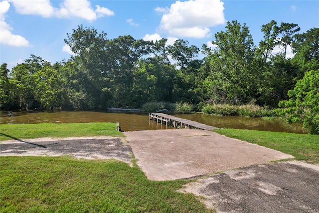 view of patio featuring a water view and a forest view
