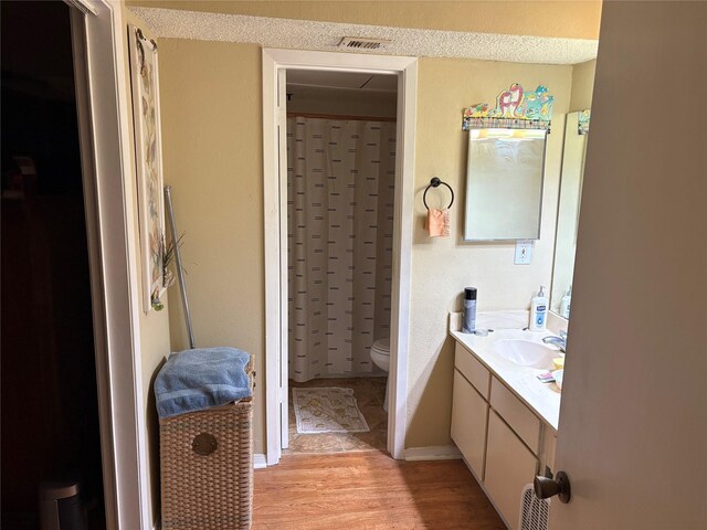 2800 Jeanetta St Unit 1110, Houston, TX 77063 - bathroom with wood finished floors, toilet, vanity, and a shower with curtain
