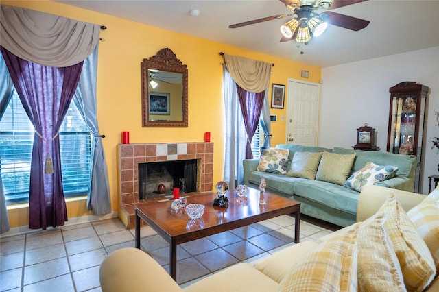 tiled living area featuring ceiling fan and a tile fireplace