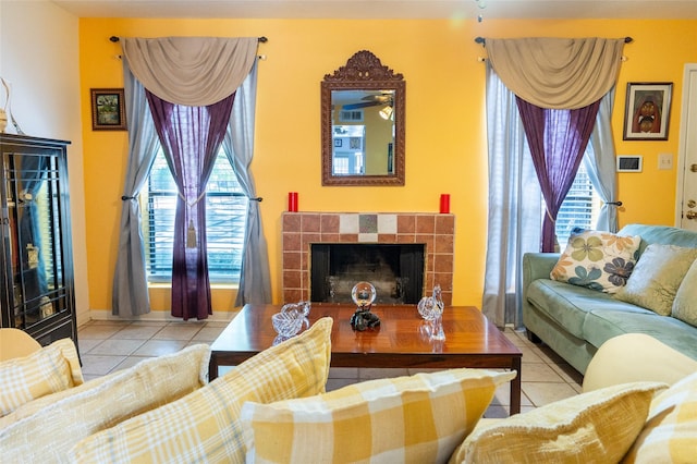 tiled living room featuring visible vents, a tile fireplace, and plenty of natural light