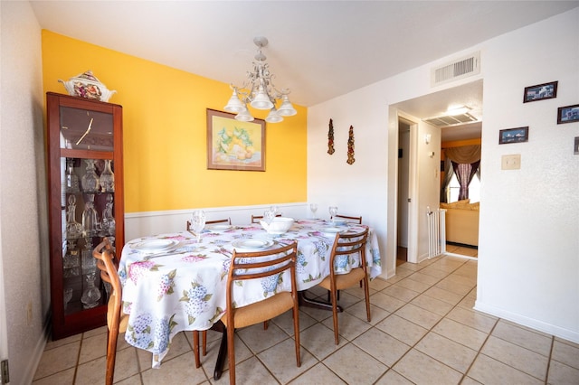 dining area featuring light tile patterned floors, an inviting chandelier, baseboards, and visible vents